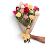 Buquê de 15 rosas coloridas em tons de vermelho, rosa e creme, com folhagens e embalagem para presente