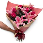 Buquê de rosas e lírios cor-de-rosa com embalagem para presente